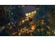 Aerial view of a two-story home surrounded by lush greenery and mature trees at 9506 S Deer Creek Canyon Rd, Littleton, CO 80127