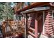 Charming log cabin exterior showcasing a cozy deck at 9506 S Deer Creek Canyon Rd, Littleton, CO 80127