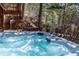 A relaxing hot tub with crystal clear water on a patio surrounded by nature at 9506 S Deer Creek Canyon Rd, Littleton, CO 80127