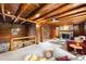 Inviting living room with a stone fireplace, cozy seating, and log cabin architecture at 9506 S Deer Creek Canyon Rd, Littleton, CO 80127