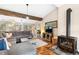 Cozy living room with wood beam, fireplace, and plush sofa, offering a relaxing and inviting atmosphere at 9506 S Deer Creek Canyon Rd, Littleton, CO 80127