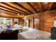 Spacious living room featuring wood beam ceilings and seamless flow to other areas at 9506 S Deer Creek Canyon Rd, Littleton, CO 80127