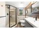 Modern bathroom featuring glass enclosed shower and wood paneled accents at 9506 S Deer Creek Canyon Rd, Littleton, CO 80127