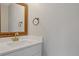 Stylish half bath with a decorative mirror, modern vanity, and designer fixtures at 13612 Plaster Cir, Broomfield, CO 80023