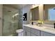 A stylish bathroom featuring a glass enclosed shower, double sinks, and grey cabinets at 13612 Plaster Cir, Broomfield, CO 80023