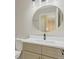 Bathroom vanity with a grey-painted cabinet and round mirror at 13612 Plaster Cir, Broomfield, CO 80023