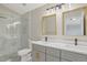 A modern bathroom featuring a glass enclosed shower, double sinks, and contemporary lighting at 13612 Plaster Cir, Broomfield, CO 80023