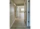 Hallway with light gray flooring and views into other rooms at 13612 Plaster Cir, Broomfield, CO 80023
