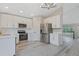 Bright, updated kitchen with white cabinetry, stainless appliances, and modern lighting fixtures at 13612 Plaster Cir, Broomfield, CO 80023