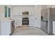 Updated kitchen featuring stainless steel appliances, white cabinets, and quartz countertops at 13612 Plaster Cir, Broomfield, CO 80023