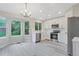 Spacious kitchen with white cabinets, stainless steel appliances, and a view of the backyard at 13612 Plaster Cir, Broomfield, CO 80023