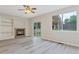 Cozy living room featuring a fireplace, built-in shelving, and a sliding glass door at 13612 Plaster Cir, Broomfield, CO 80023