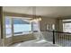 Bright living room featuring stylish gray flooring, complemented by large windows and modern lighting fixtures at 13612 Plaster Cir, Broomfield, CO 80023