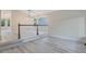Bright living room featuring stylish gray flooring, complemented by large windows and modern lighting fixtures at 13612 Plaster Cir, Broomfield, CO 80023