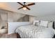 Bright bedroom featuring a ceiling fan, neutral walls, natural light, and a comfortably made bed at 5420 Allison St # 202, Arvada, CO 80002