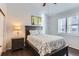 Charming bedroom with a dark wood frame bed, neutral walls, and shutters for ample natural light at 5420 Allison St # 202, Arvada, CO 80002