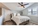 Cozy bedroom featuring neutral walls, a ceiling fan, natural light, and a comfortably made bed at 5420 Allison St # 202, Arvada, CO 80002