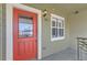 Charming entryway featuring a vibrant red door, well-lit with a stylish wall lamp at 5420 Allison St # 202, Arvada, CO 80002