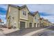 A row of two-story townhomes with individual garages and neutral siding, offering modern living at 5420 Allison St # 202, Arvada, CO 80002