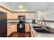 Efficient kitchen with light wood cabinets and black appliances at 5420 Allison St # 202, Arvada, CO 80002