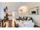 Open-concept living room features soaring ceilings, sleek hardwood floors and stylish lighting at 5420 Allison St # 202, Arvada, CO 80002