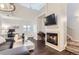 Bright and modern living room with high ceilings, fireplace, and hardwood floors at 5420 Allison St # 202, Arvada, CO 80002