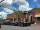 Charming outdoor seating at a brick building, featuring ample umbrellas for shade and an inviting street view at 5420 Allison St # 202, Arvada, CO 80002