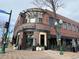 Corner restaurant featuring a brick exterior, outdoor seating, and modern architectural details for a stylish dining experience at 5420 Allison St # 202, Arvada, CO 80002