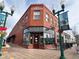 Classic brick building with large storefront windows, vintage-style lighting, and a charming neighborhood setting at 5420 Allison St # 202, Arvada, CO 80002