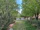 A street view is framed by lush greenery, providing a serene and inviting atmosphere with several cars parked on the street at 5420 Allison St # 202, Arvada, CO 80002