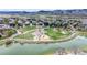 Scenic aerial view of a community park with a pond, playground, and walking trails at 9804 N Crystal Lake Dr, Littleton, CO 80125