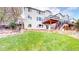 Spacious backyard featuring a deck, stone wall, and well-maintained lawn at 9804 N Crystal Lake Dr, Littleton, CO 80125
