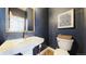 Chic half bathroom featuring a modern sink, elegant mirror, and stylish decor at 9804 N Crystal Lake Dr, Littleton, CO 80125
