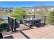 Deck featuring outdoor seating, a lake view, and lush trees at 9804 N Crystal Lake Dr, Littleton, CO 80125