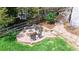 Backyard featuring a stone firepit, seating and a small grassy yard at 9804 N Crystal Lake Dr, Littleton, CO 80125