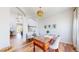 Bright home office with a large desk, chair, modern decor and lovely hardwood floors at 9804 N Crystal Lake Dr, Littleton, CO 80125