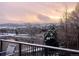 Peaceful view of a snow-covered community with a serene pond and mountain backdrop at 9804 N Crystal Lake Dr, Littleton, CO 80125