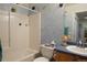 Whimsical bathroom with blue accents, a combined tub/shower, and decorative fish accents at 2296 E 109Th Dr, Northglenn, CO 80233
