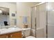 Well-lit bathroom featuring a vanity, toilet, and shower stall with sliding glass doors at 2296 E 109Th Dr, Northglenn, CO 80233
