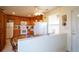 Bright kitchen featuring tile flooring, wood cabinets, white appliances, and an adjacent breakfast nook at 2296 E 109Th Dr, Northglenn, CO 80233