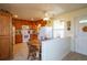 Bright kitchen featuring tile flooring, wood cabinets, white appliances, and an adjacent breakfast nook at 2296 E 109Th Dr, Northglenn, CO 80233