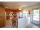 Bright kitchen featuring tile flooring, wood cabinets, white appliances, and an adjacent breakfast nook at 2296 E 109Th Dr, Northglenn, CO 80233