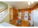 Bright kitchen featuring tile flooring, wood cabinets, white appliances, and an adjacent breakfast nook at 2296 E 109Th Dr, Northglenn, CO 80233