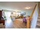 Open-concept living room featuring hardwood floors, neutral paint, lots of natural light, and a dining area and staircase at 2296 E 109Th Dr, Northglenn, CO 80233