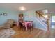 Cozy living room with hardwood floors, neutral paint, lots of natural light, and a dining area and staircase at 2296 E 109Th Dr, Northglenn, CO 80233