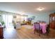 Spacious living room with a ceiling fan, hardwood floors, neutral paint, lots of natural light, and a dining area at 2296 E 109Th Dr, Northglenn, CO 80233