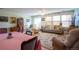 Inviting living room with hardwood floors, neutral paint, lots of natural light, and dining area and furniture at 2296 E 109Th Dr, Northglenn, CO 80233