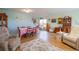 Well-lit living room featuring hardwood floors, neutral paint, lots of natural light, and a dining area and staircase at 2296 E 109Th Dr, Northglenn, CO 80233