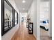 Bright hallway with hardwood floors, mirrors, and a view into the living room and bedroom at 5107 Ditmars Ln, Castle Rock, CO 80104