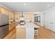 Modern kitchen with light wood cabinets, large island, and stainless steel appliances at 5107 Ditmars Ln, Castle Rock, CO 80104